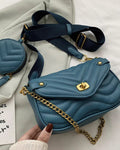Blue quilted handbag with gold chain and matching round pouch on a light background