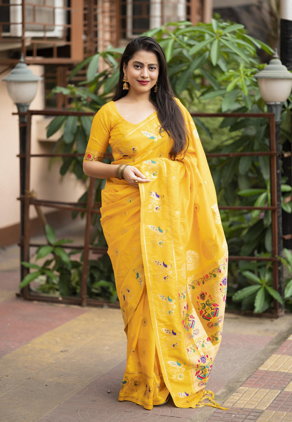 Yellow pure silk saree with intricate woven zari design and pallu tassels