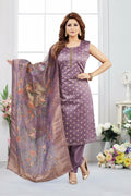 Woman wearing a lilac jacquard kurta set with gold geometric accents and a floral dupatta