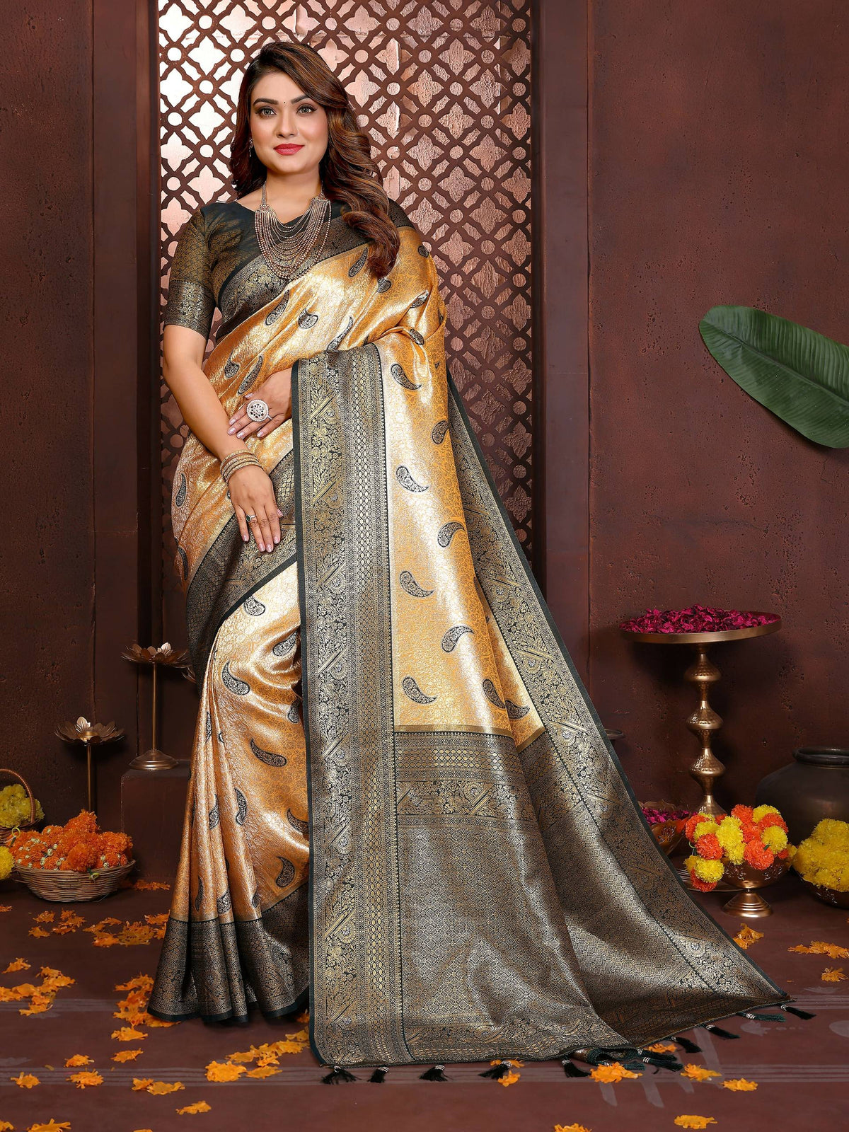 Close-up of a mustard tissue silk saree with intricate woven details and an elegant sheen.