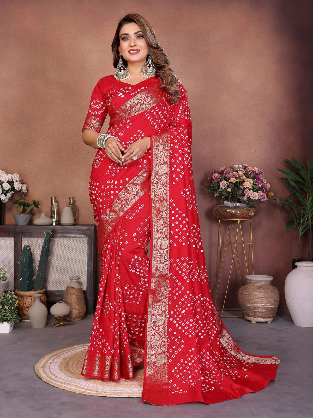 A stunning red pure Dola silk saree with intricate handmade Bandhej pattern for festive occasions.