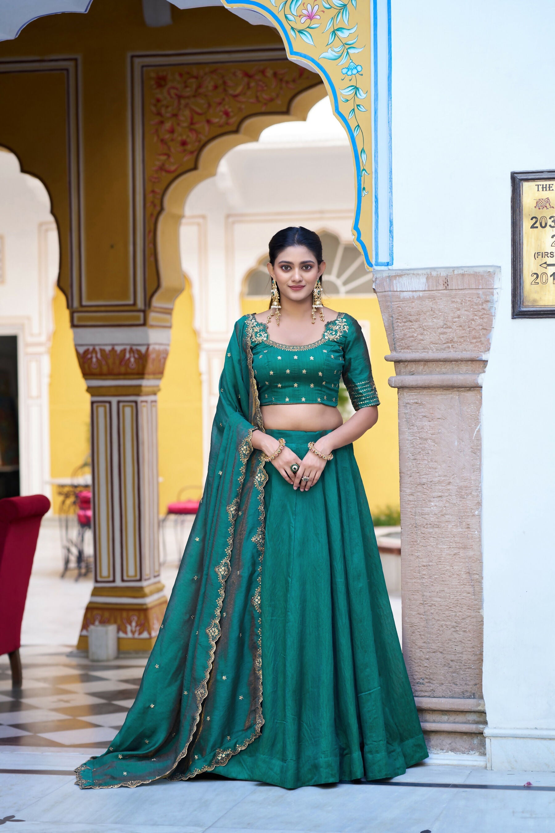 Teal NC Silk lehenga paired with a detailed embroidered choli.