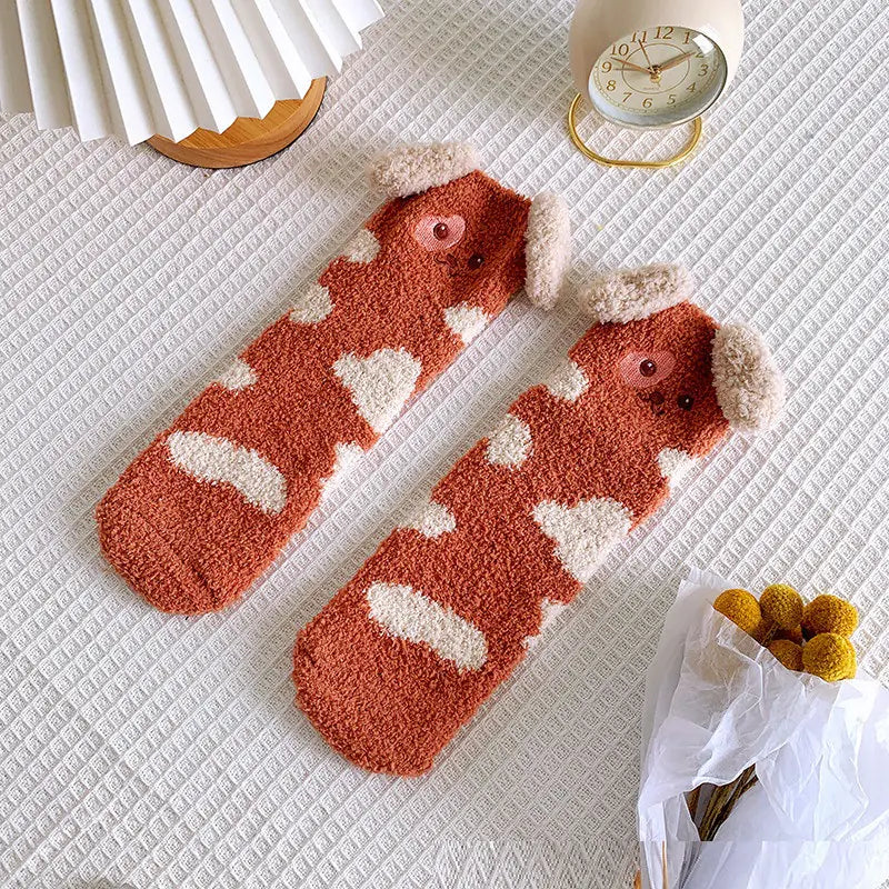 A pair of orange and white coral fleece mid-tube socks with a puppy face design and 3D ears.