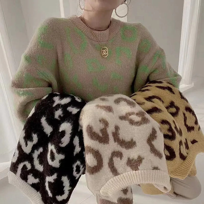 Woman wearing a cozy yellow and brown leopard print pullover sweater, showcasing its relaxed fit and crew neck design, with other leopard print swatches.