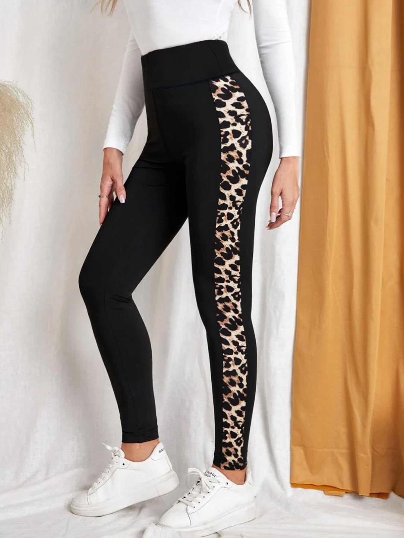 Close up of leopard print high-waist butt-lifting yoga pants on a fitness model