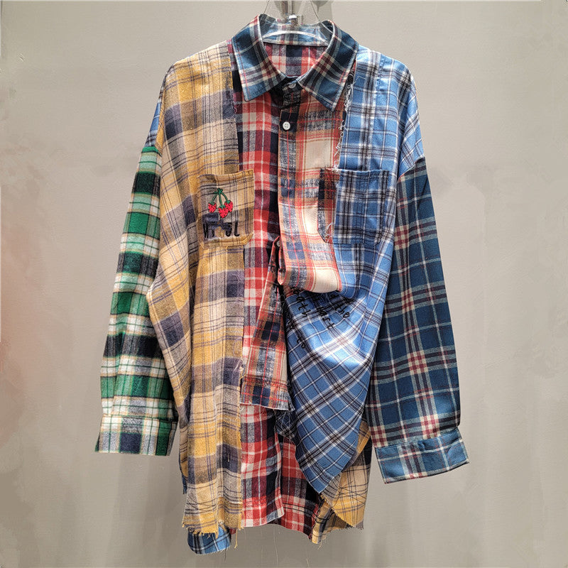 Front view of women's multi-color patchwork plaid loose fit shirt featuring red, blue, yellow, and green patterns, a collared neckline, button-front, and distressed hem.