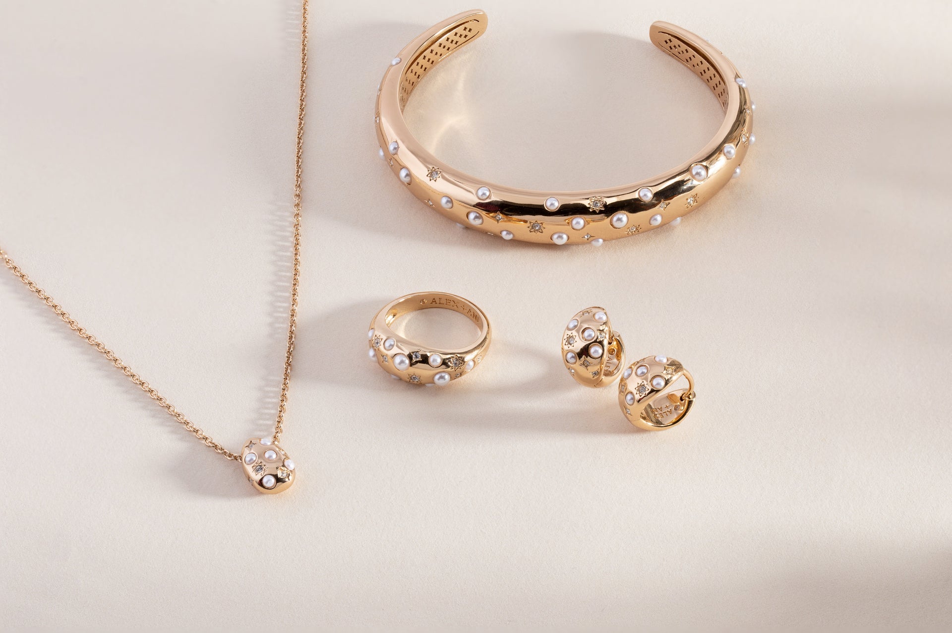 Pearl and Crystal Huggie Hoop Earrings in Gold with Starburst