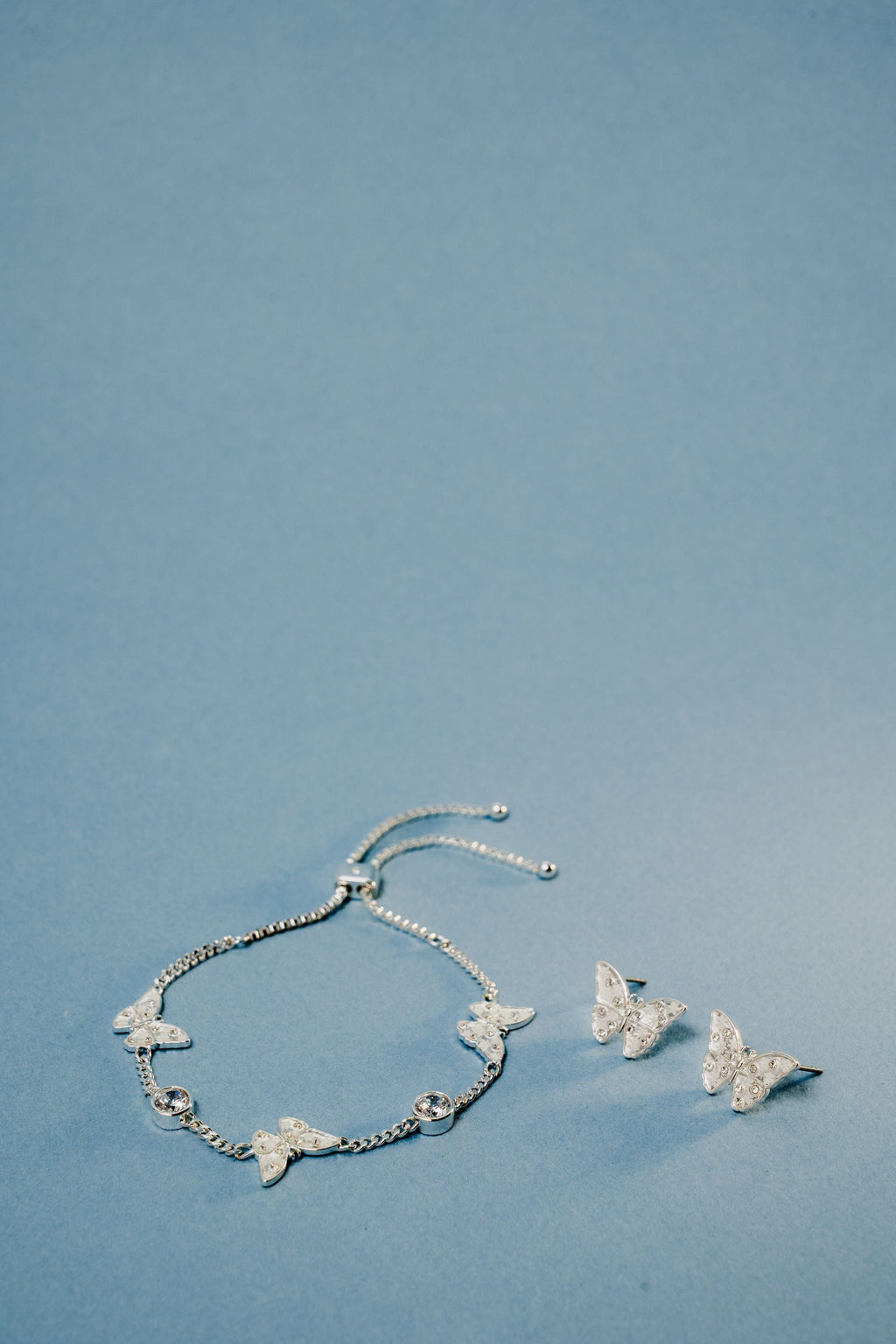 Glass Butterfly Statement Stud Earrings with Shimmering Snowflakes
