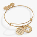 Gold affirmation bangle featuring a crystal-embellished butterfly charm that slides to reveal a hidden message