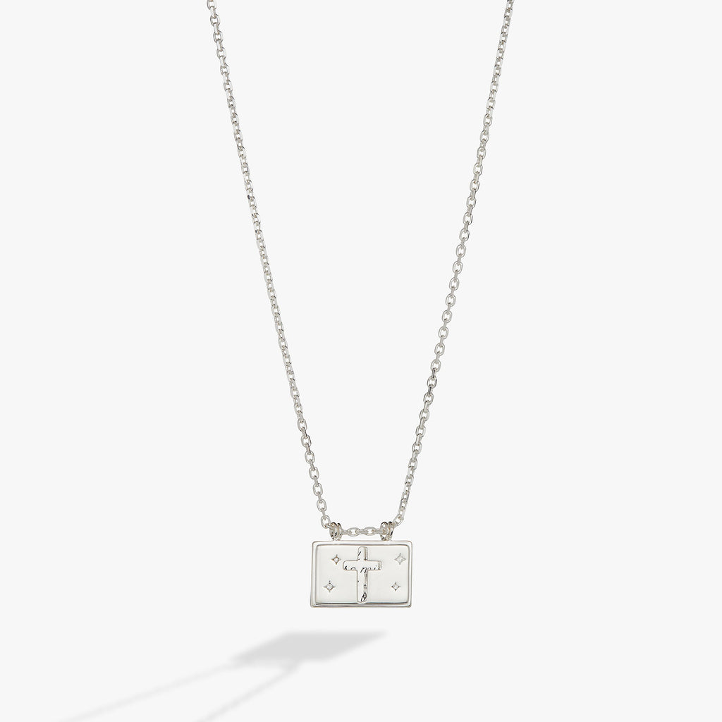 Polished silver cross pendant necklace with hidden affirmation message and crystal accents