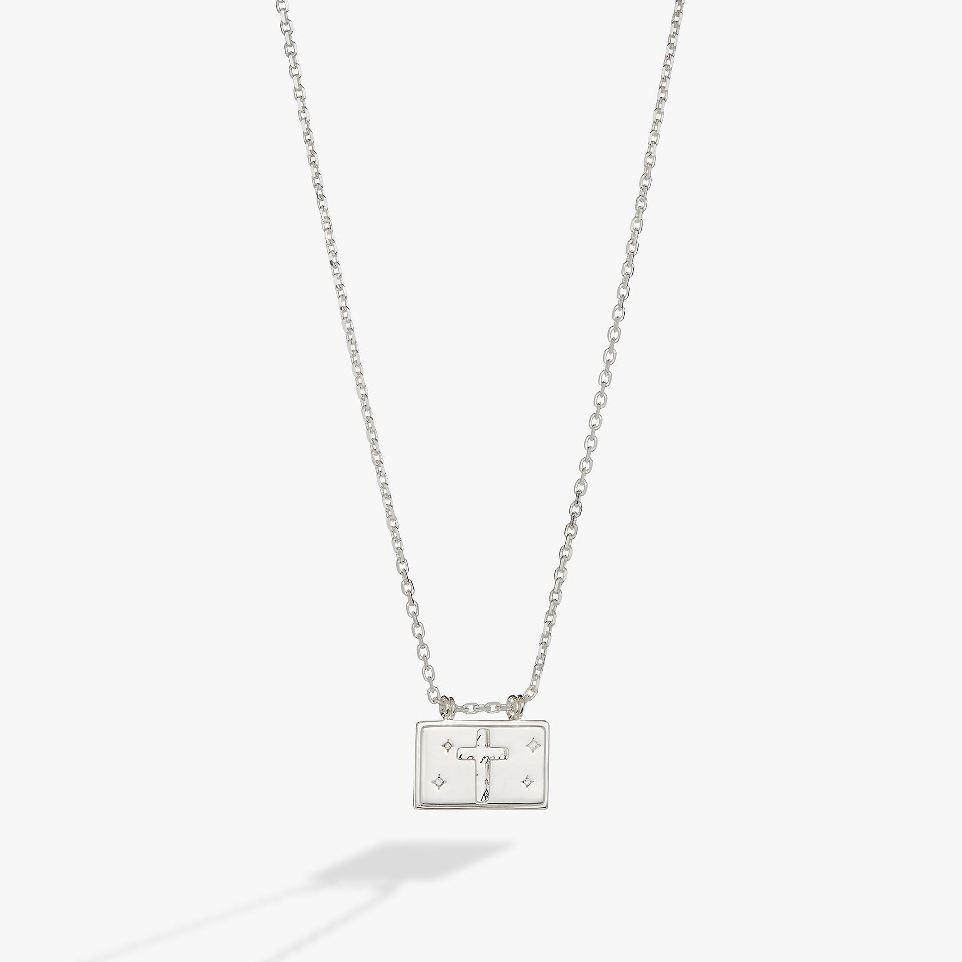 Polished silver cross pendant necklace with hidden affirmation message and crystal accents