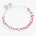 Expandable silver wire bangle with pink faceted glass beads and a breast cancer awareness ribbon charm.
