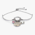 Transformation Trio charm bracelet featuring a mother of pearl butterfly and pearlized enamel floral charms.