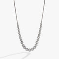 Elegant crystal tennis necklace in silver and gold, featuring clear cubic zirconia crystals and a lobster clasp closure.