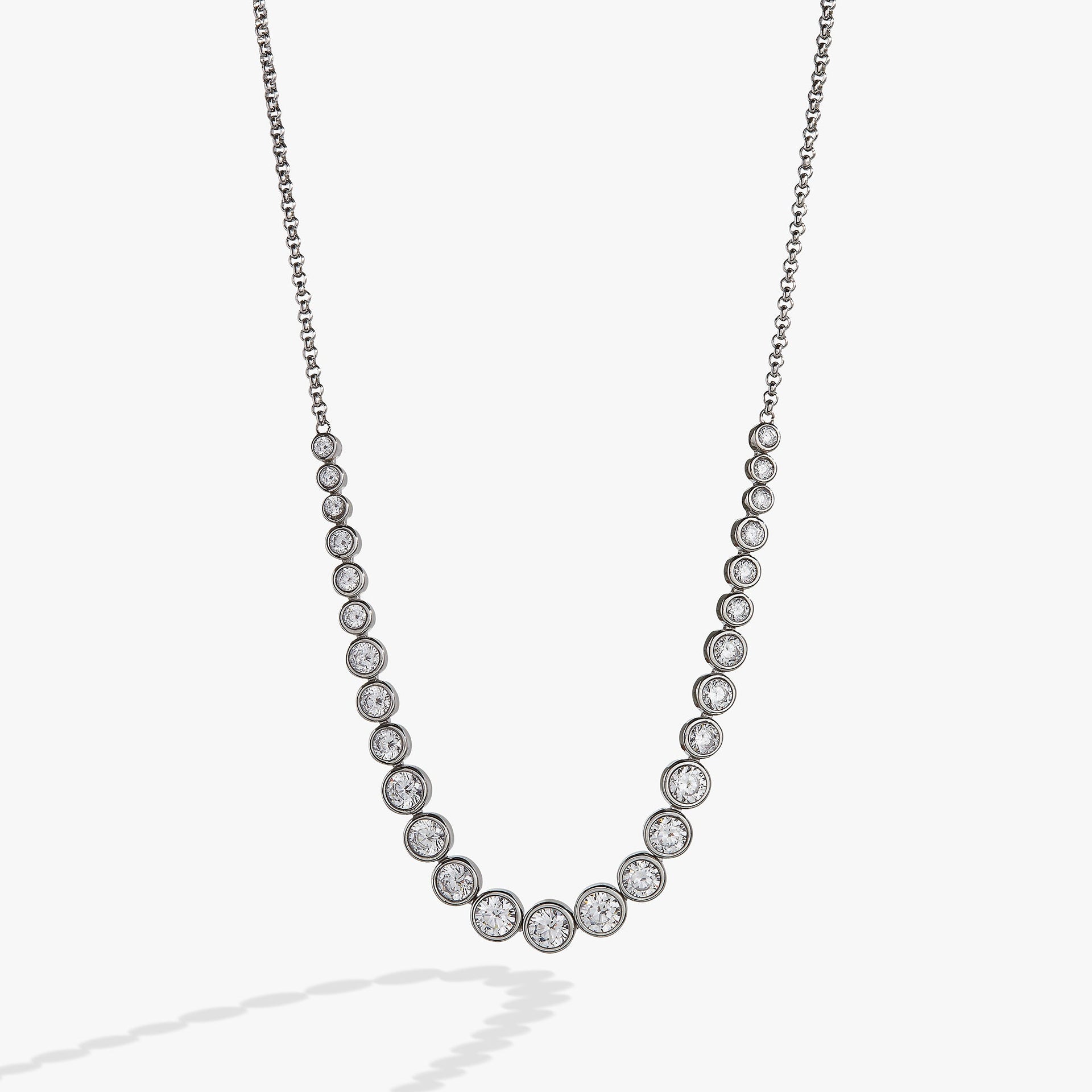 Elegant crystal tennis necklace in silver and gold, featuring clear cubic zirconia crystals and a lobster clasp closure.