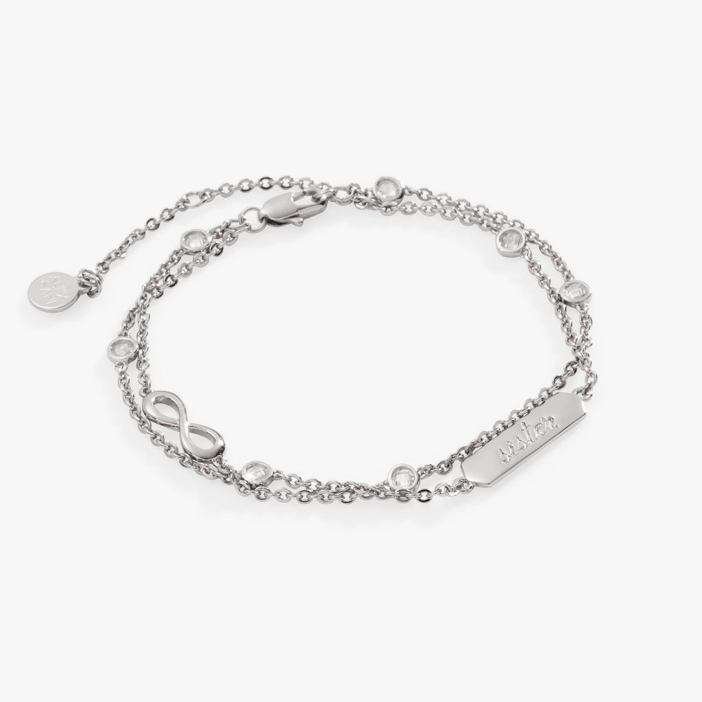 Double strand chain bracelet with a Sister plate and an infinity symbol set with clear crystals.