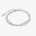 Double strand chain bracelet with a Sister plate and an infinity symbol set with clear crystals.