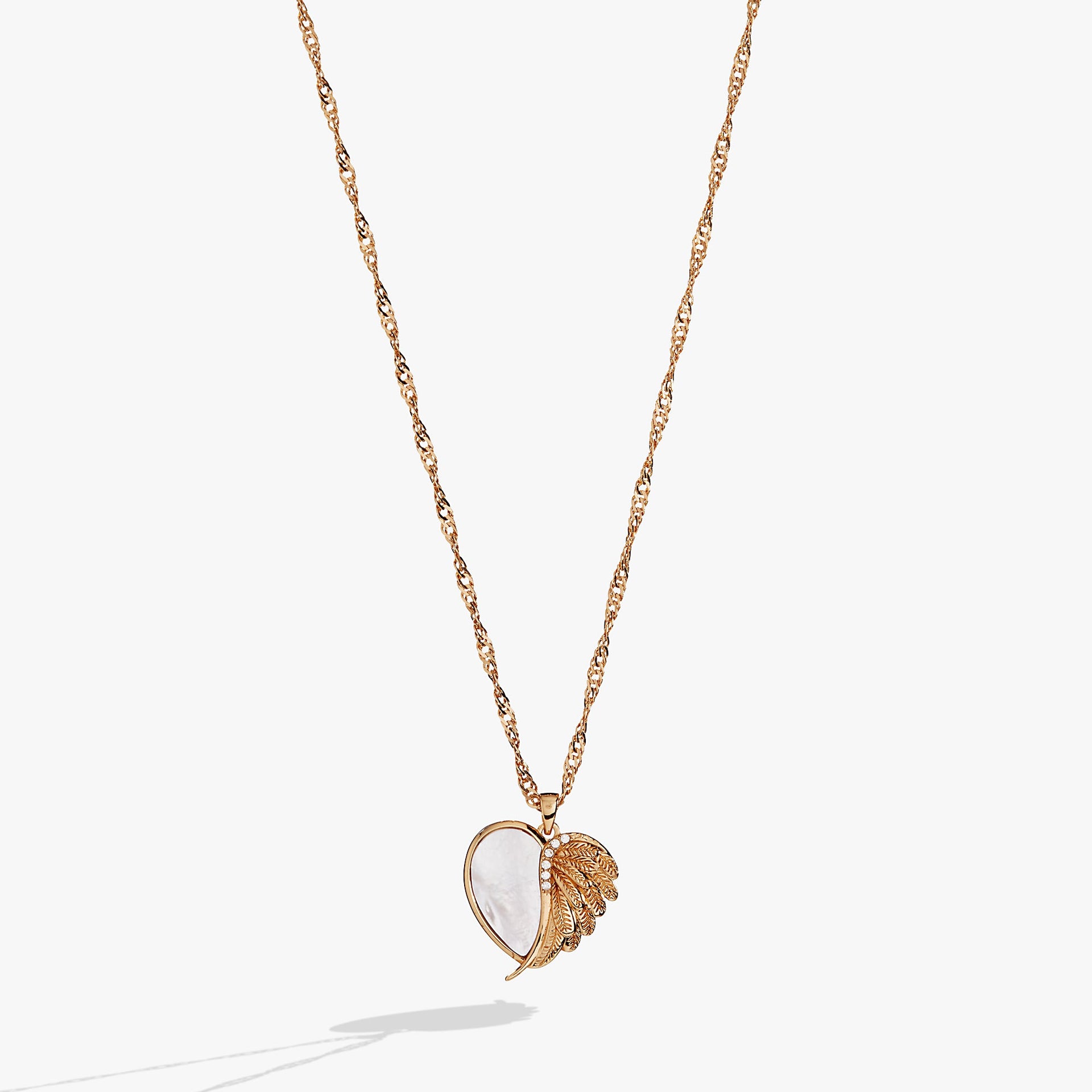 Heart-shaped charm necklace with Mother of Pearl and angel wing detail featuring glass crystals.