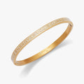 Neutral enamel hinge bangle featuring the mantra Your Energy Is Your Currency in bold block lettering.