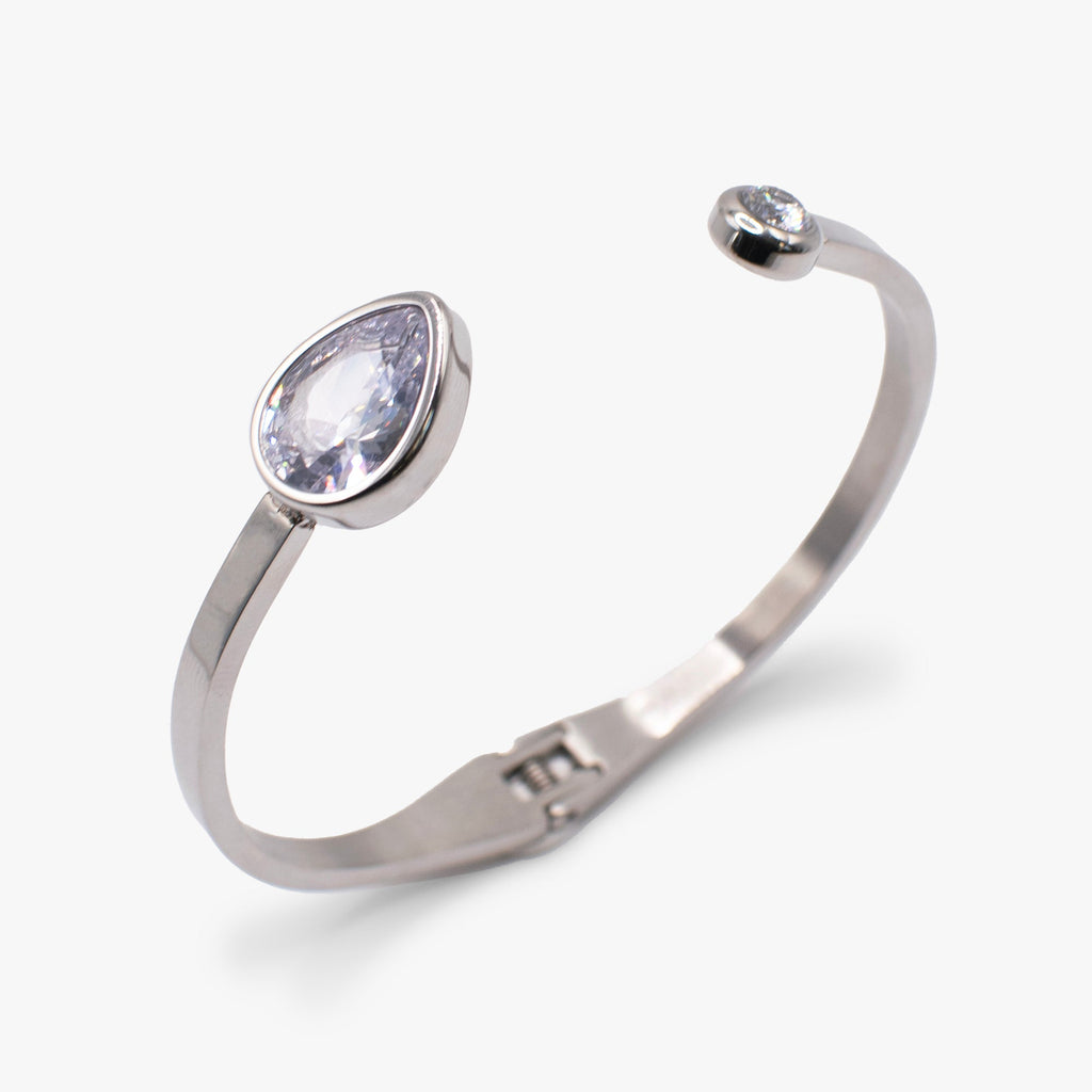 Crystal hinge cuff bracelet featuring a clear teardrop stone on a polished metal band.