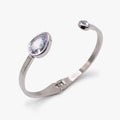 Crystal hinge cuff bracelet featuring a clear teardrop stone on a polished metal band.