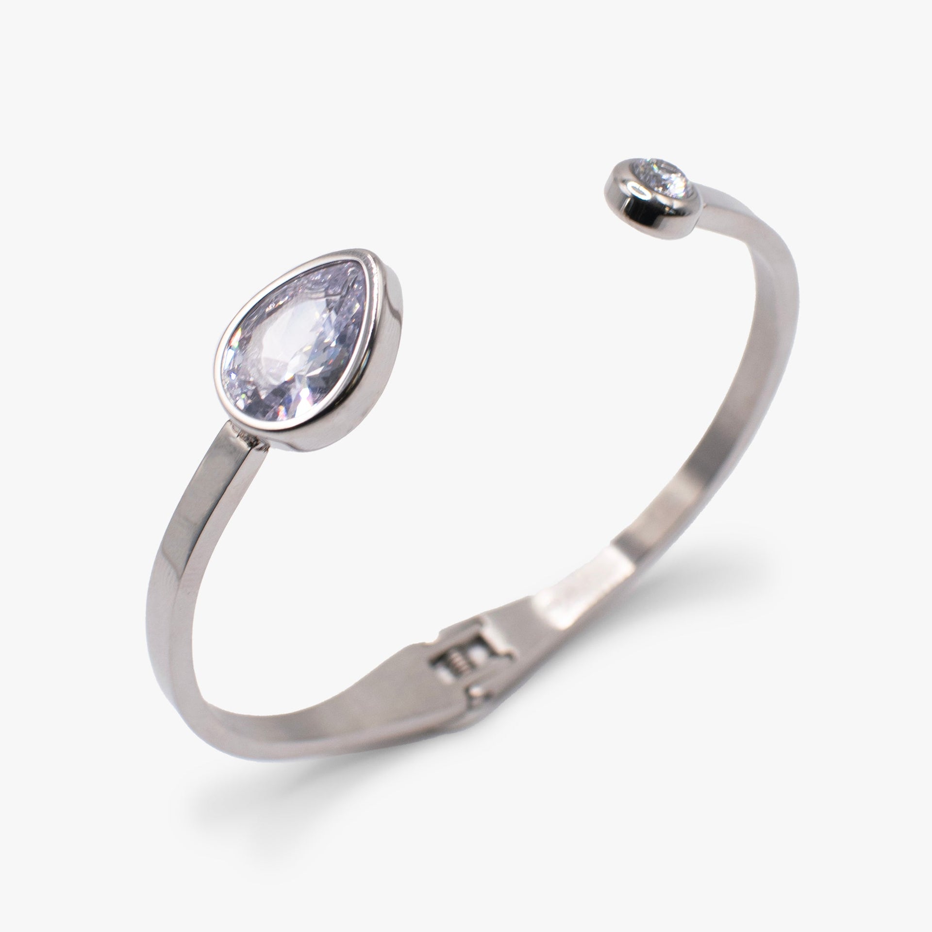 Crystal hinge cuff bracelet featuring a clear teardrop stone on a polished metal band.