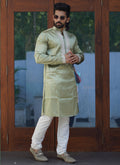 Baby boy wearing a Mehendi green silk kurta with intricate coding work and matching pajama set.