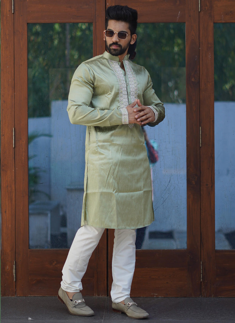 Baby boy wearing a Mehendi green silk kurta with intricate coding work and matching pajama set.