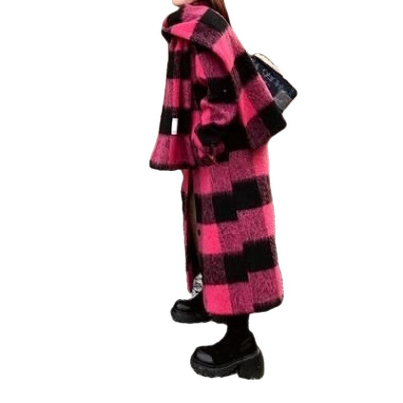 Woman wearing a long, loose-fit pink and black plaid woolen coat in a Harajuku style.