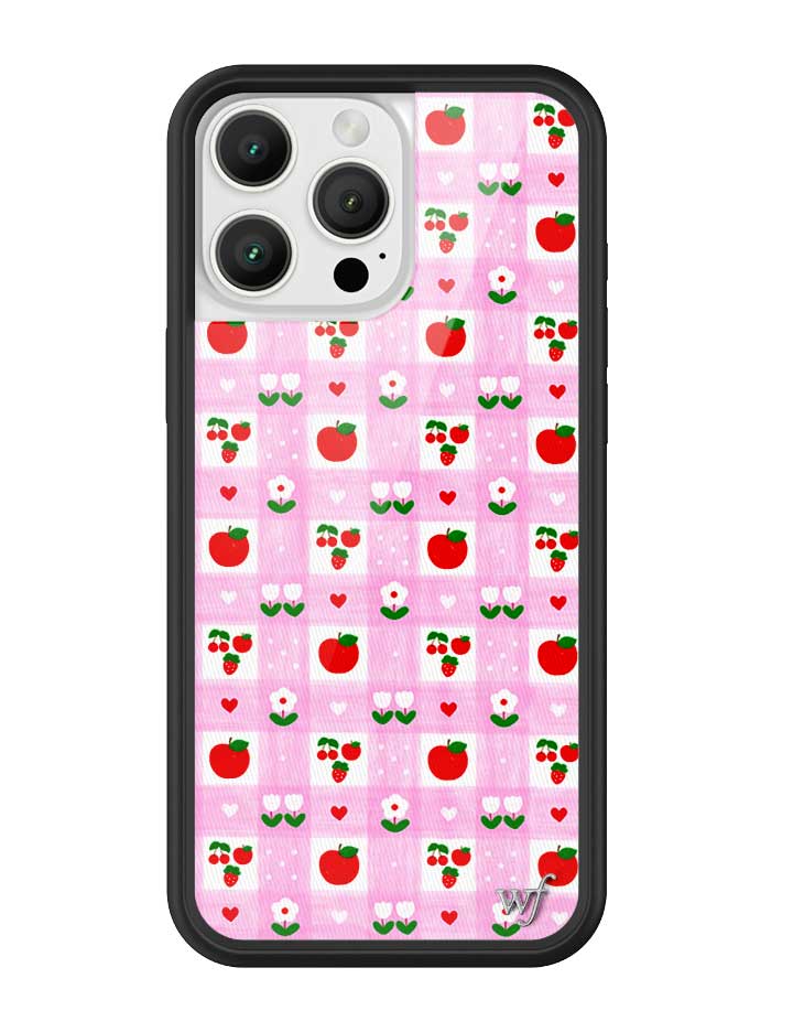 An Apple a Day iPhone case featuring a pink and white gingham pattern with red apples, flowers, and hearts, framed by a black rubber bumper.