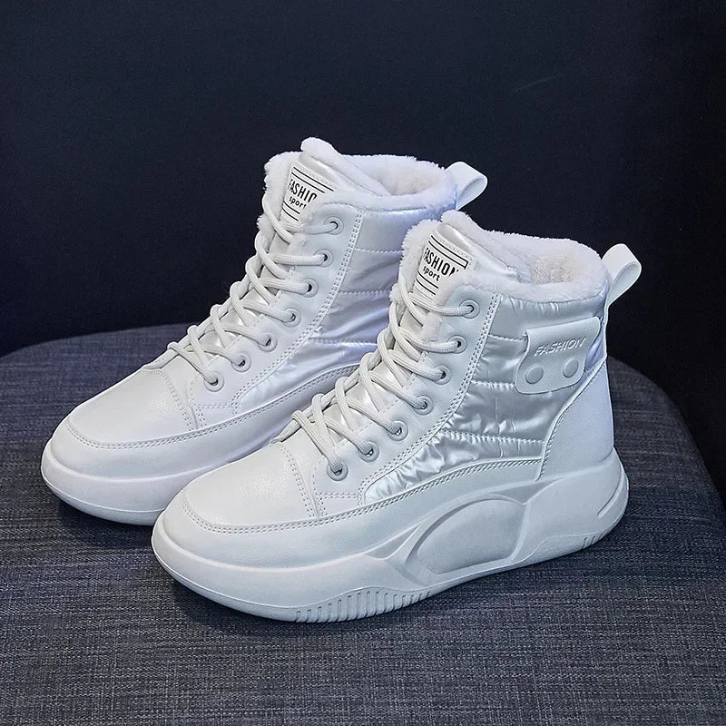 A pair of women's plush-lined white winter snow boots with lace-up closure and non-slip rubber sole.