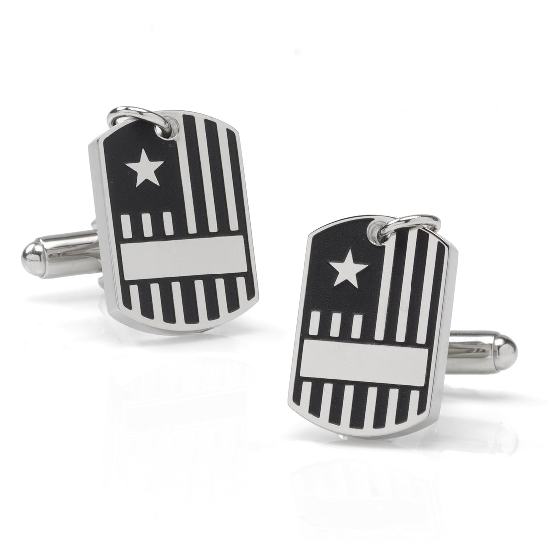 Close up of silver-tone military dog tag style cufflinks with flag design worn on a white dress shirt cuff.