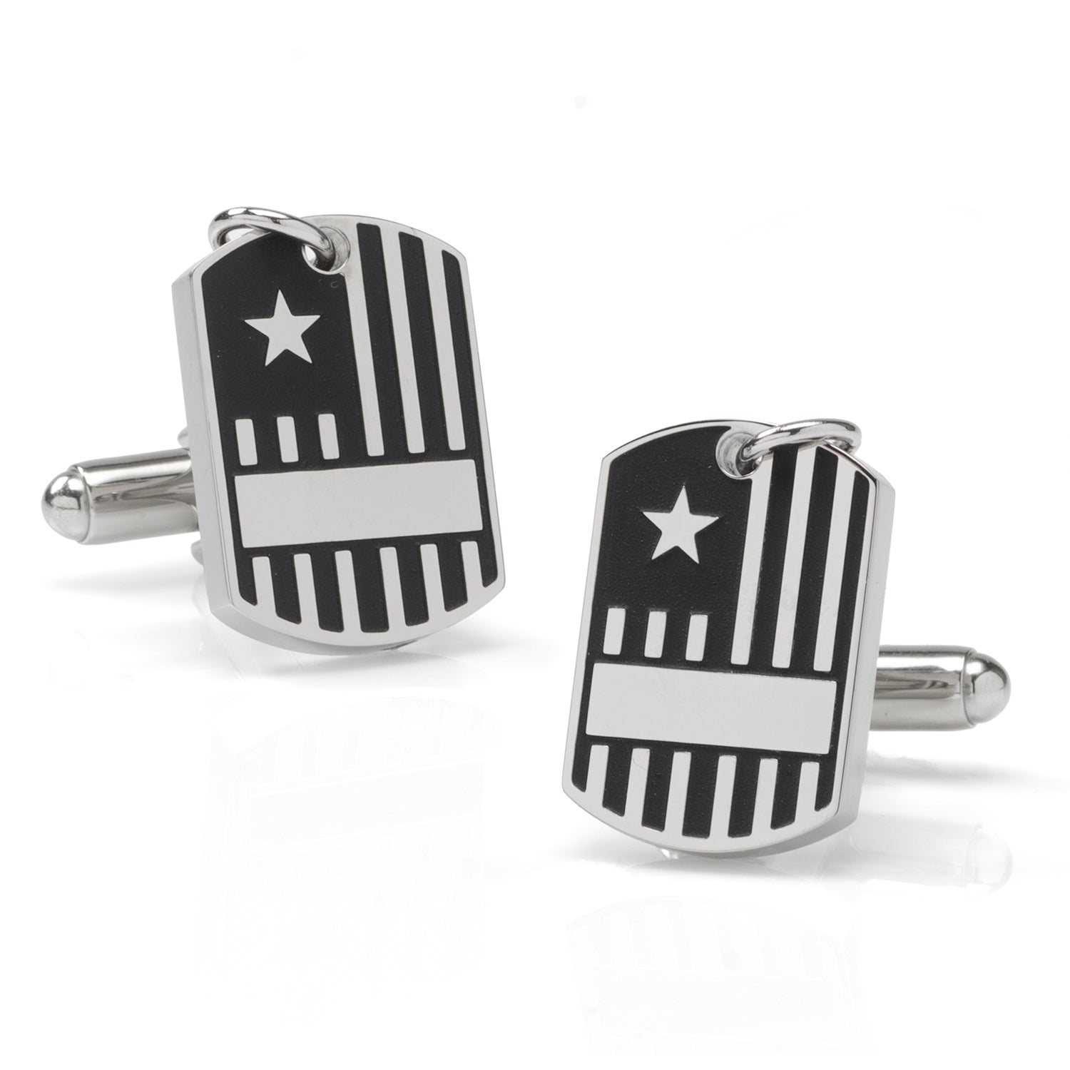 Close up of silver-tone military dog tag style cufflinks with flag design worn on a white dress shirt cuff.