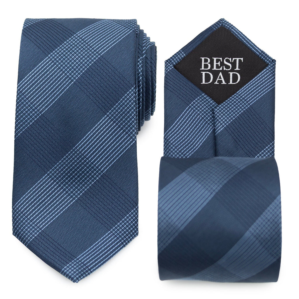 Close-up view of a dark blue plaid necktie with 'BEST DAD' printed on the interior tipping.