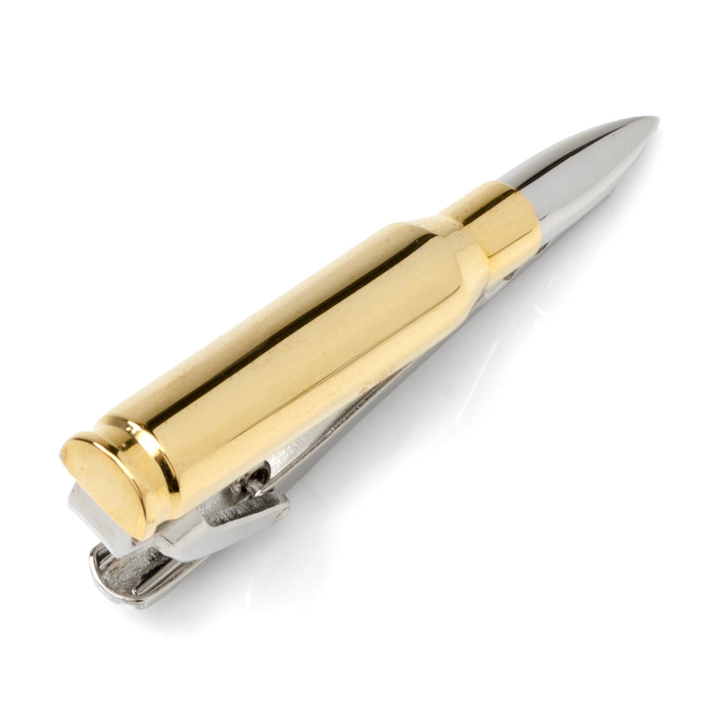 Close up of a 50 caliber bullet shaped tie clip with gold casing and silver tip