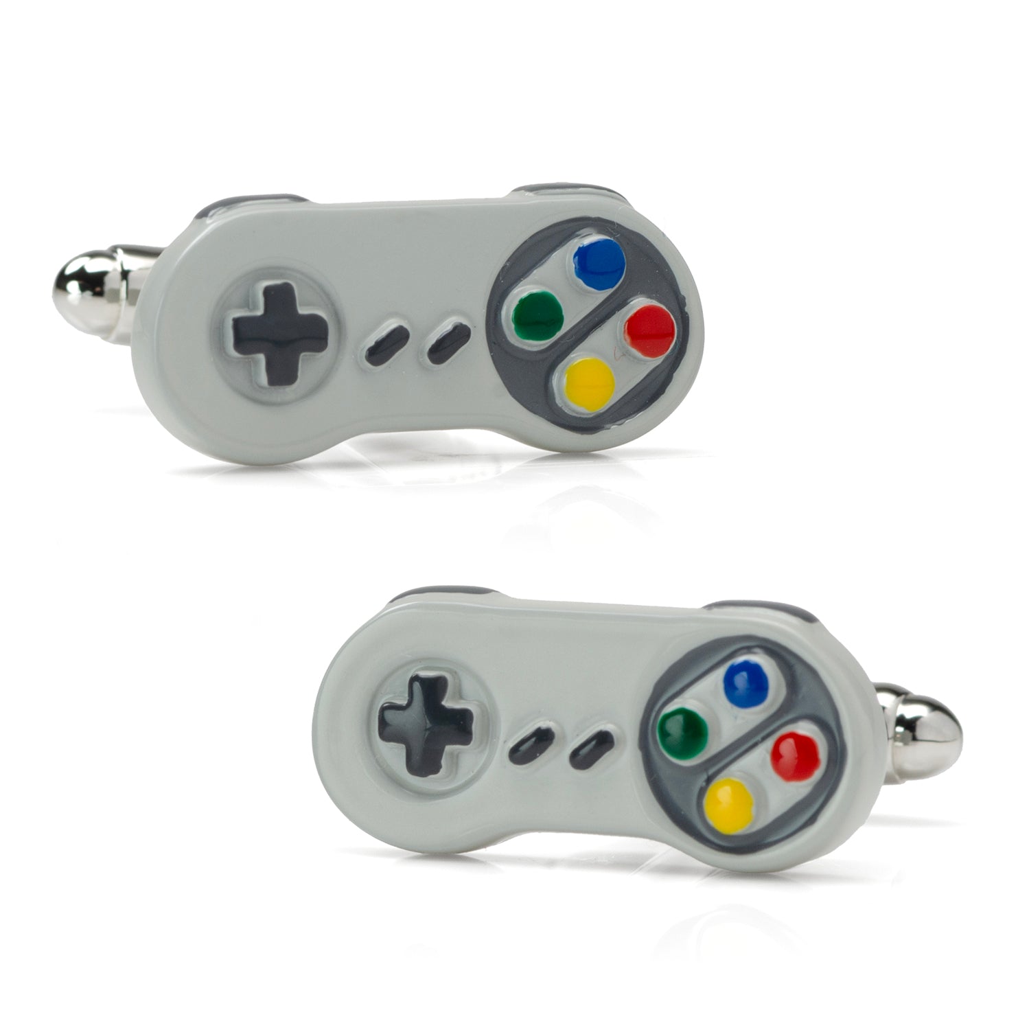 A pair of vintage game controller shaped cufflinks with a gray body and red, blue, green, and yellow buttons shown on a white dress shirt cuff.