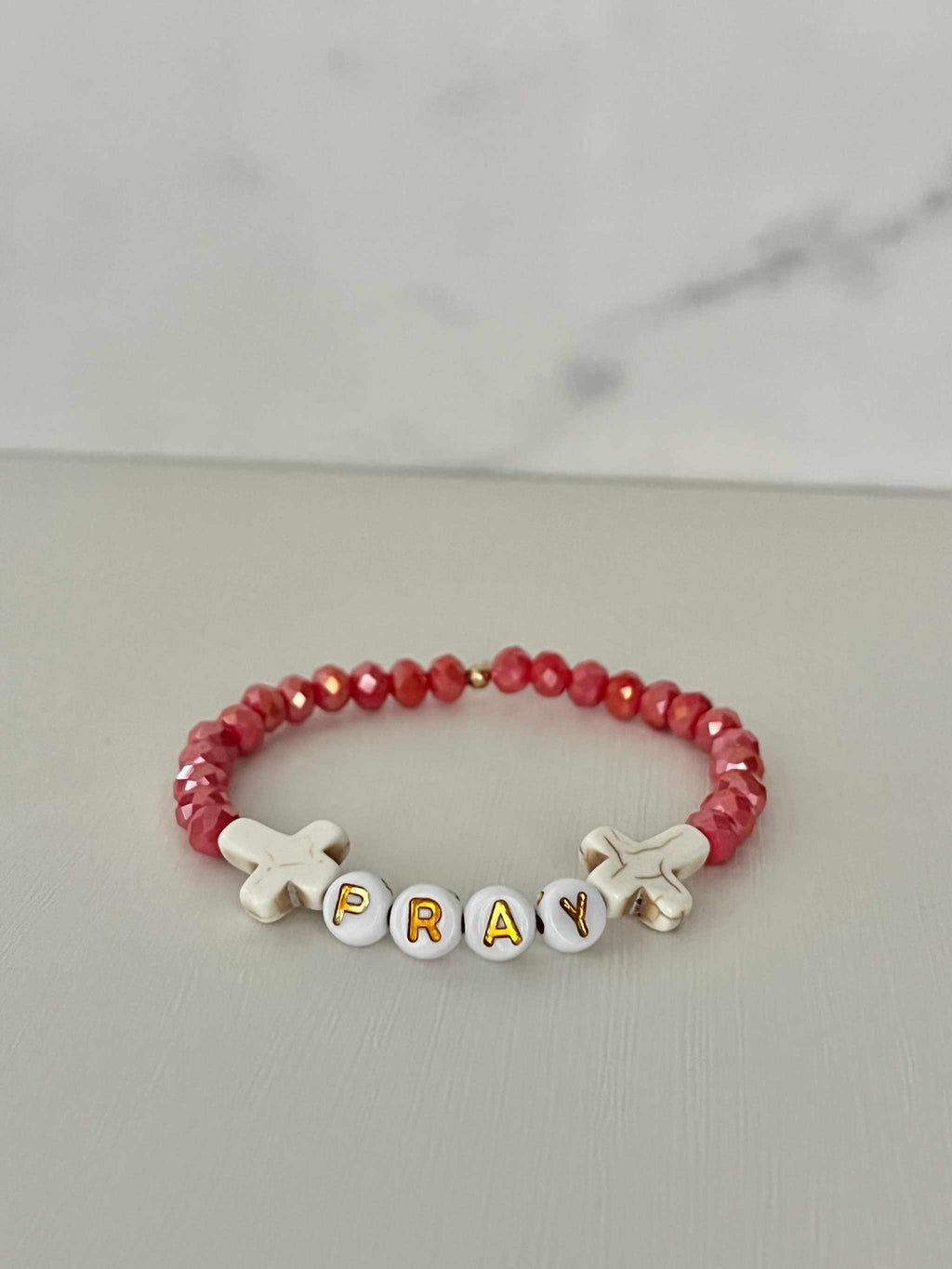 Pray Red Faceted Beaded Bracelet showing the letters P-R-A-Y on the bead sequence.