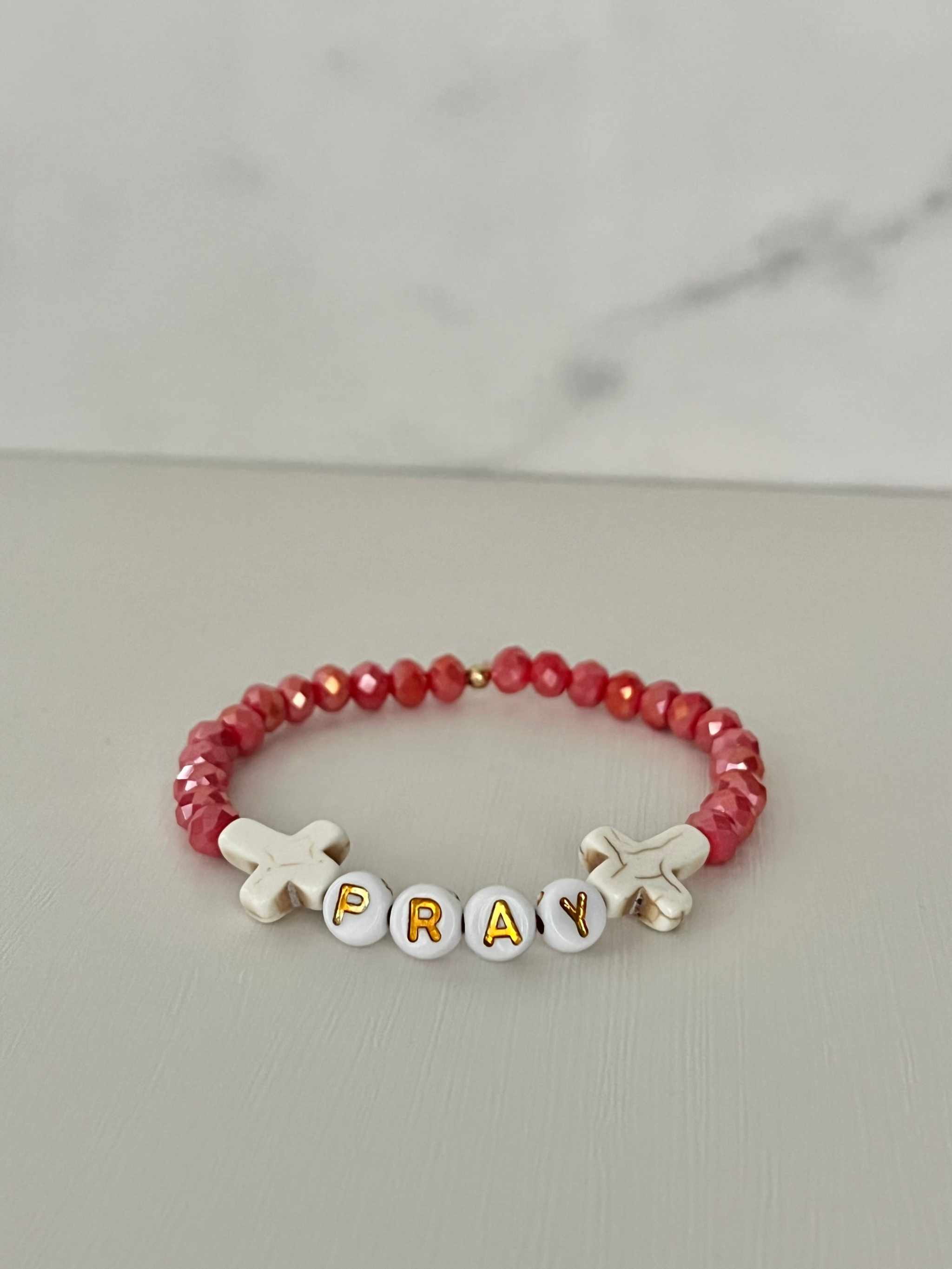 Pray Red Faceted Beaded Bracelet showing the letters P-R-A-Y on the bead sequence.