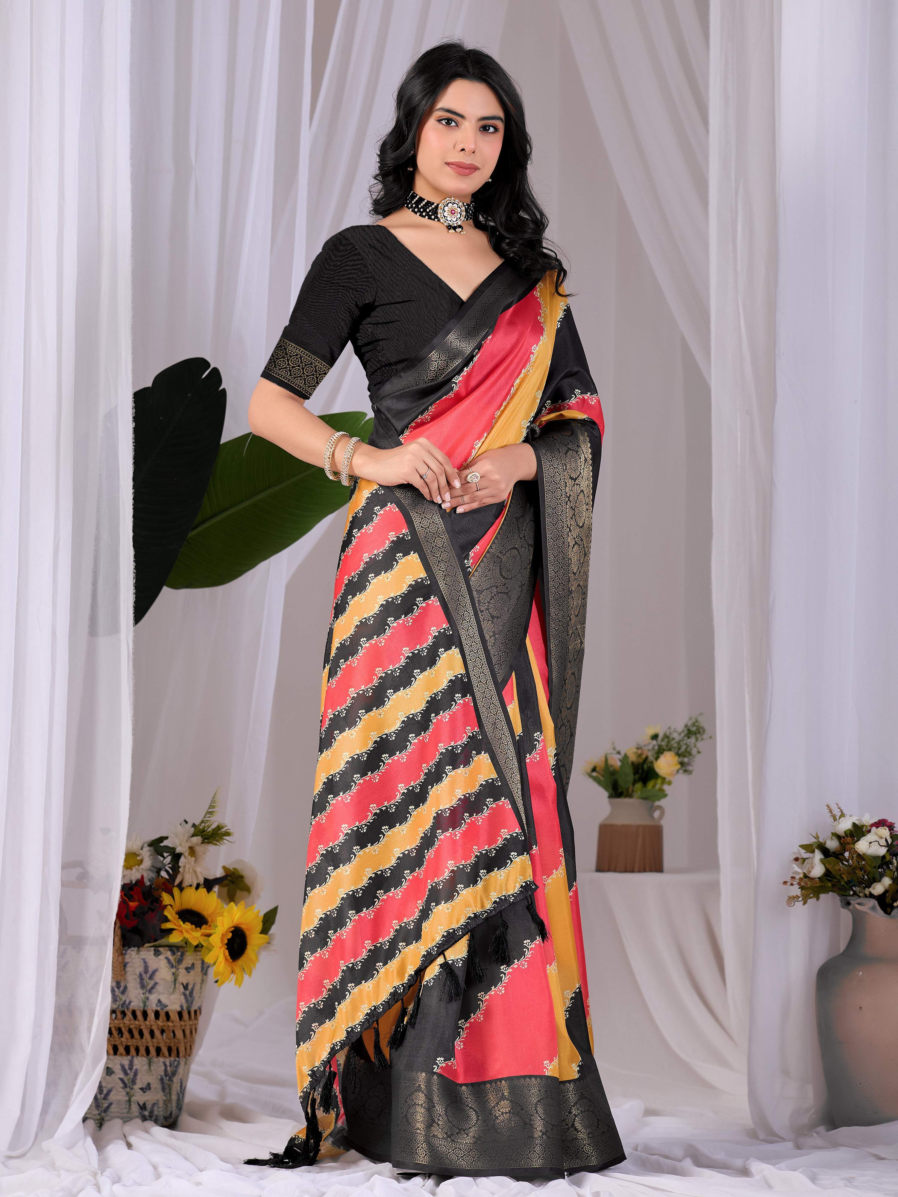 Aastha Fashion multi-colored soft Lichi silk printed saree with a solid black blouse piece.