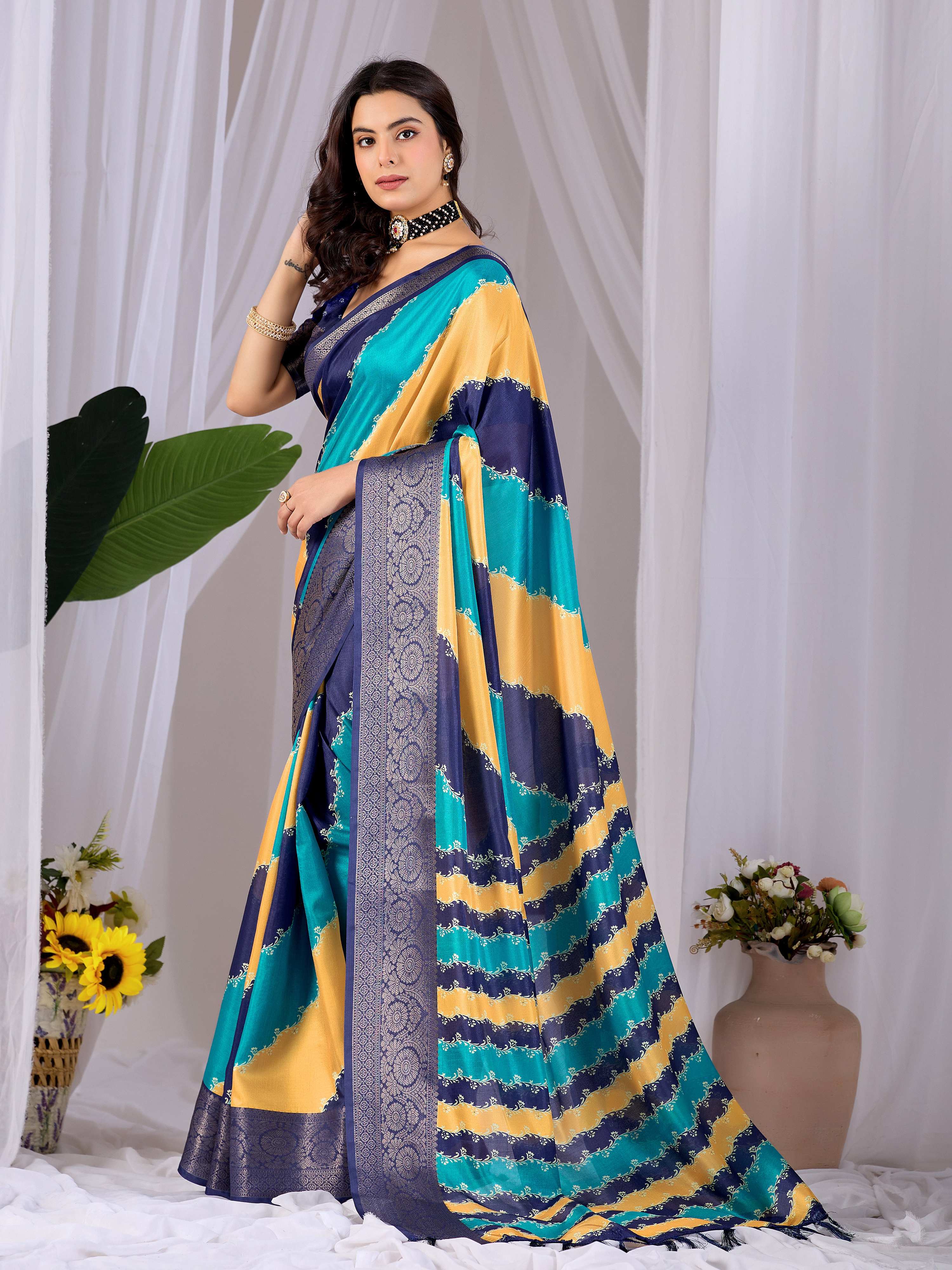 A beautiful multi-colored soft Lichi silk printed saree paired with a navy blue blouse.