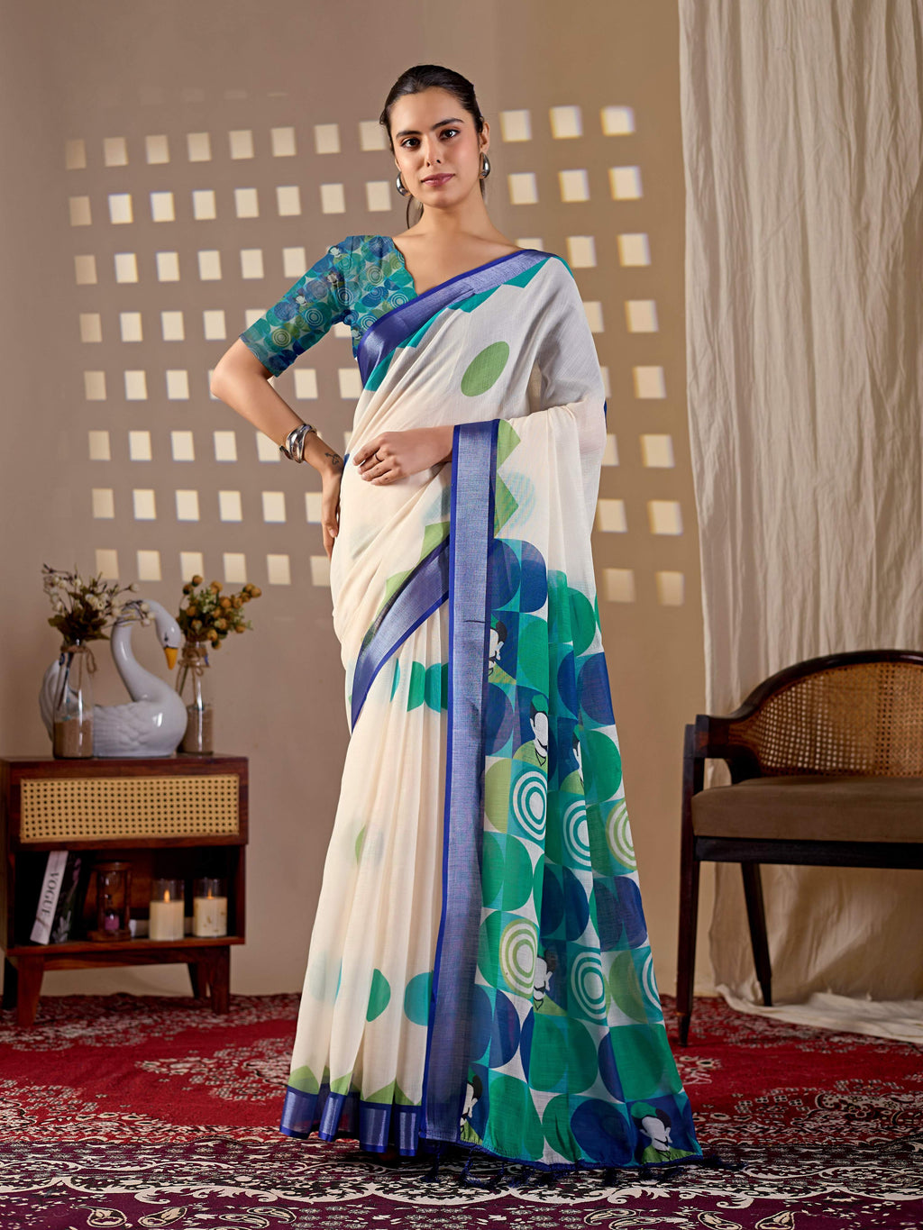 A chic cream linen cotton printed saree styled with a refreshing aqua blue blouse.