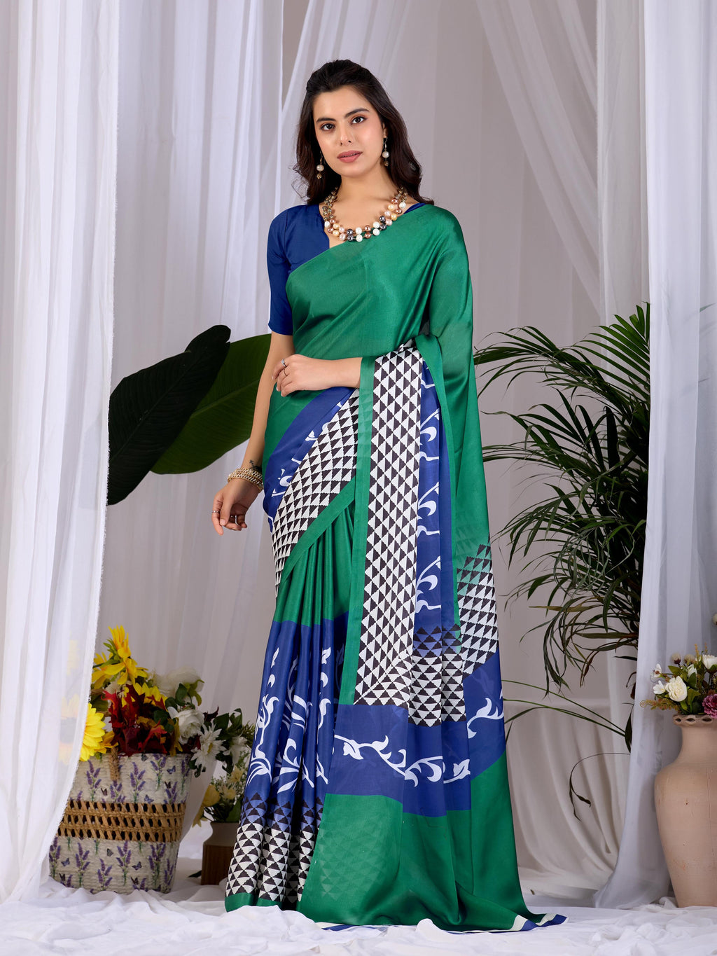 Green soft satin georgette printed saree paired with a blue blouse