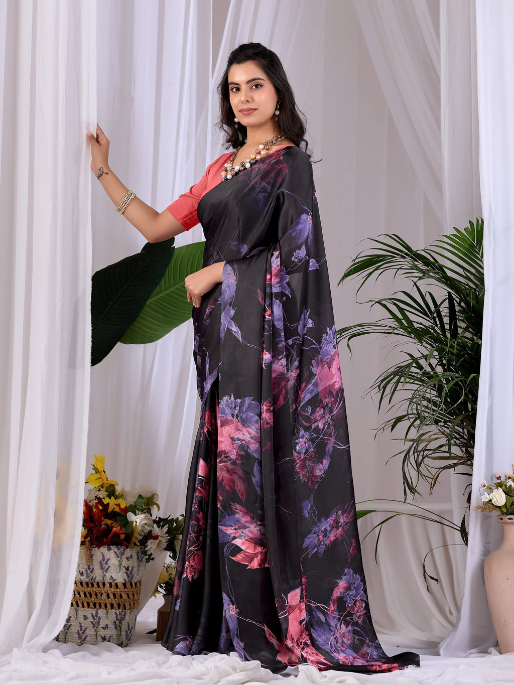 Aastha Fashion black soft satin georgette printed saree with peach blouse detail