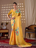 A vibrant yellow soft satin georgette printed saree with matching blouse draped elegantly.