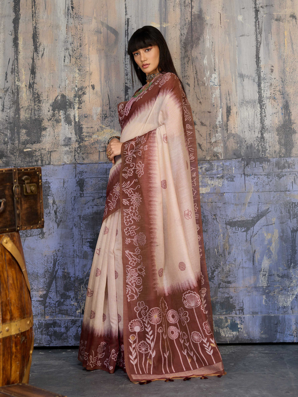 A sophisticated brown Munga Cotton printed saree featuring intricate patterns and a matching blouse.