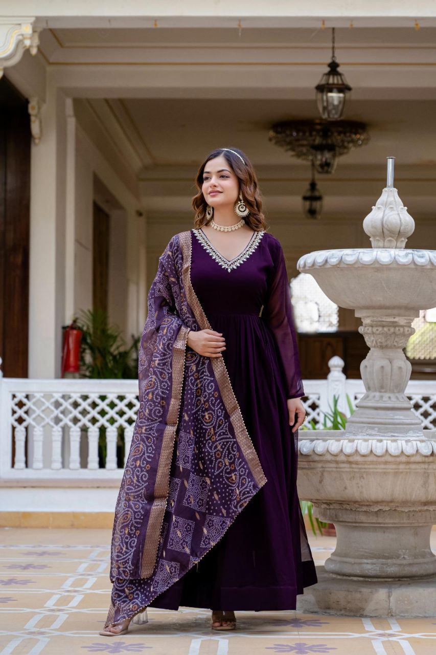 Wine colored faux georgette gown with pearl embellishments and matching dupatta