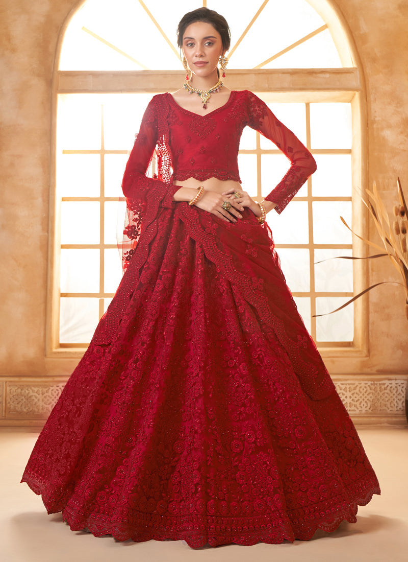 Vibrant red net wedding lehenga featuring intricate thread work and matching dupatta
