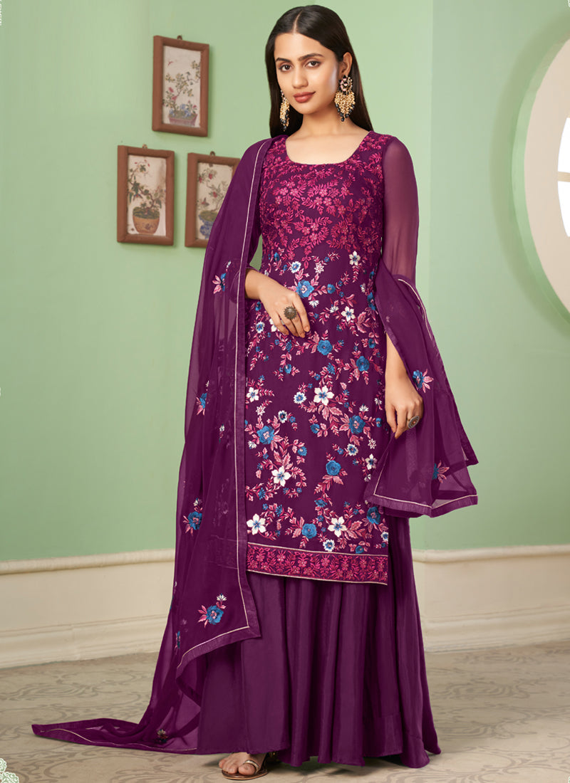 Woman wearing a violet floral embroidered chiffon A-line sharara suit with dupatta