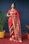 Women wearing a vibrant red Paithani silk saree with intricate gold zari woven details and a matching blouse.