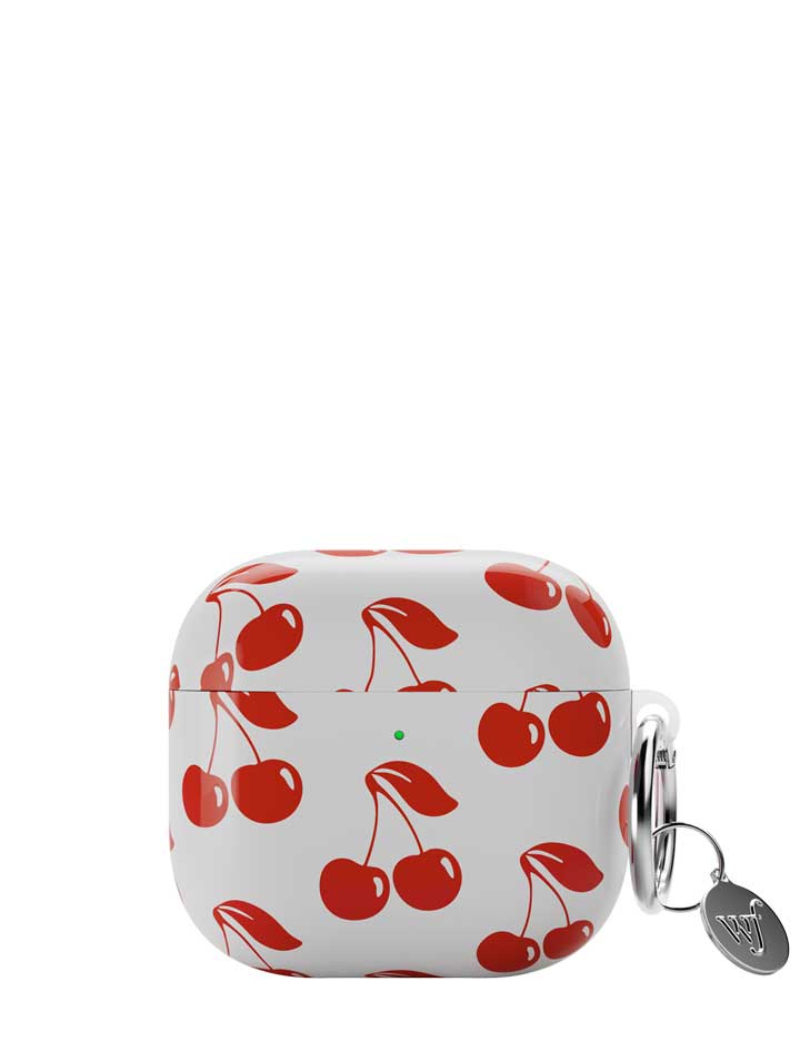 White AirPods case with a red cherry pattern and an attached silver keyring.